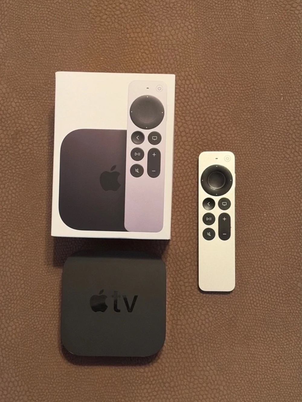 Apple TV 4K 1st Gen streaming box with White and Black Siri Remote